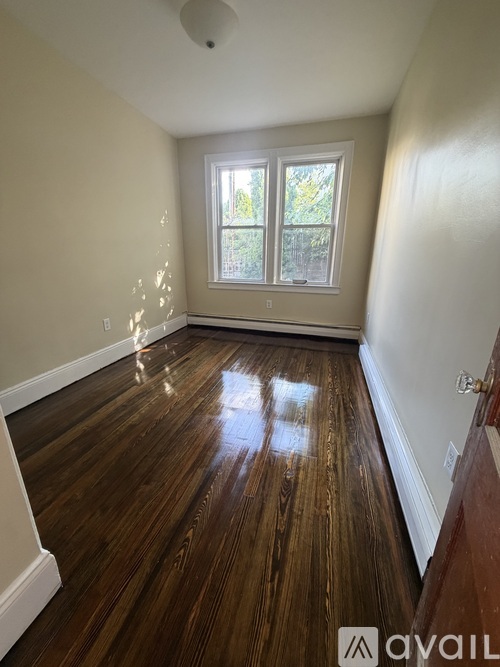 A room with wooden floors and a window.