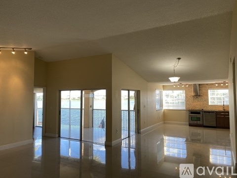 A spacious room with a pool table and a bar area.
