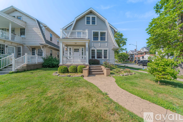 A house with a front yard and a walkway leading to the front door.