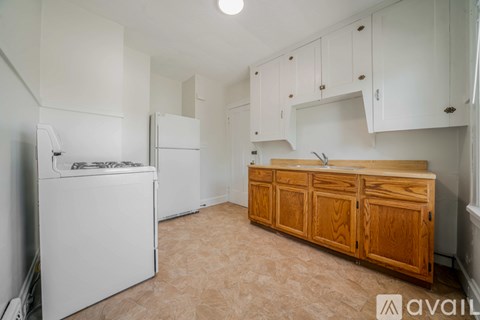 A kitchen with wooden cabinets and a white dishwasher.