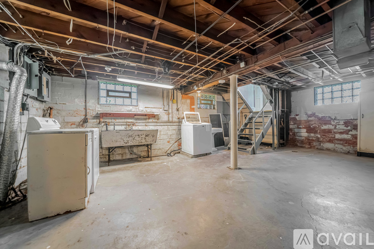 A large, empty industrial space with exposed ceiling beams and ductwork.