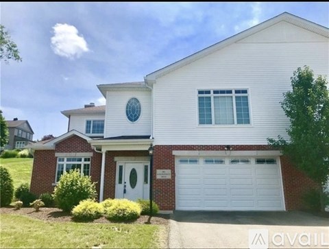 A house with a white garage door is for sale.