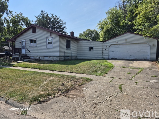 A two-story house with a garage is for sale.