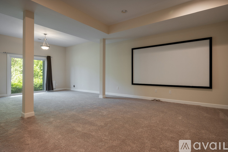 A spacious room with a large blank picture frame on the wall.