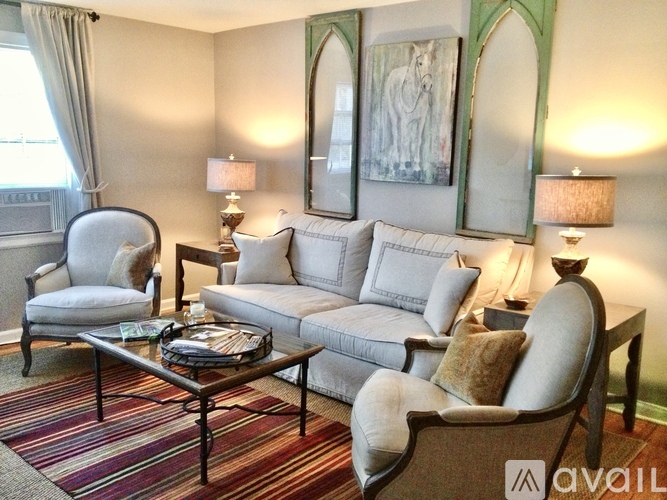 A living room with a sofa, armchair, and coffee table.