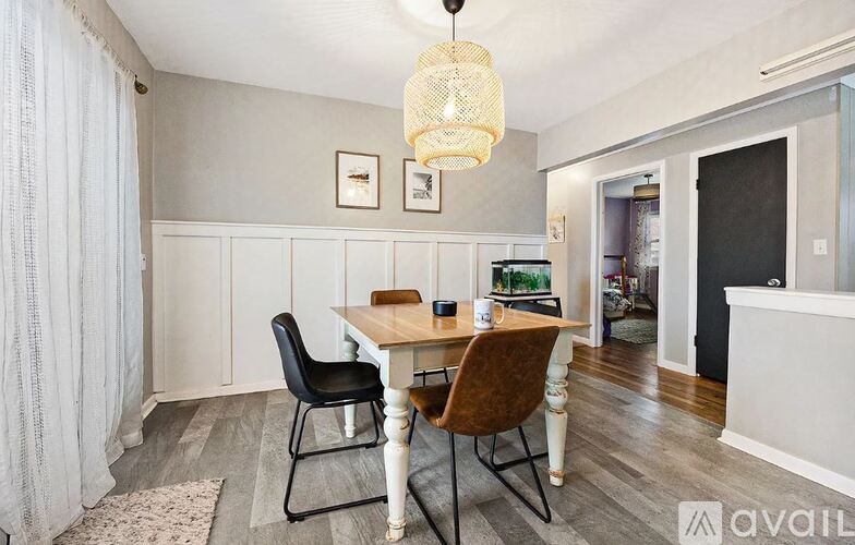 A dining room with a table and chairs.