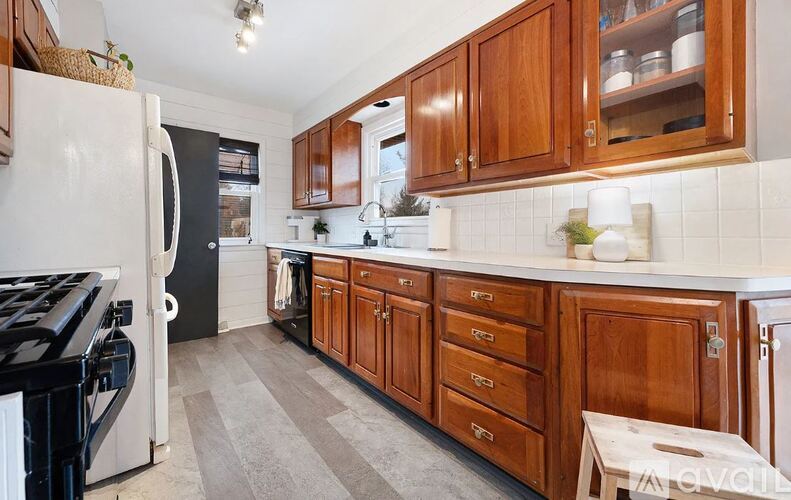 A kitchen with wooden cabinets and a black stove top.