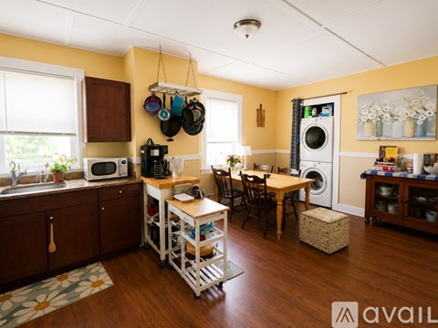 A kitchen with a table and chairs in the middle of the room.