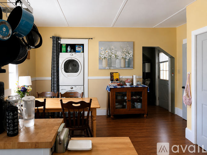 A kitchen with a washing machine in the background.