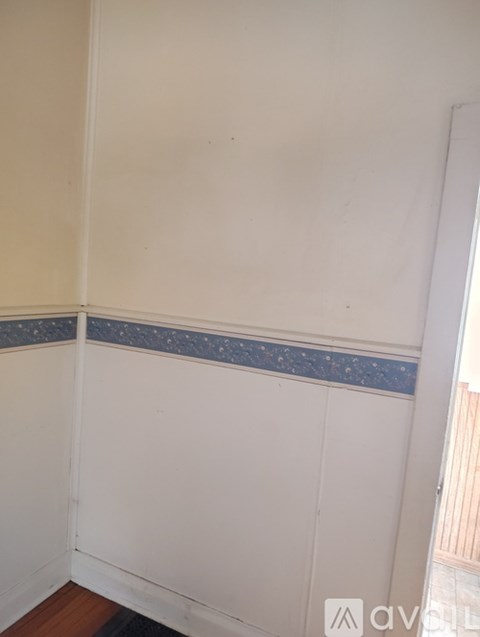 A white wall with a blue decorative border at the bottom.