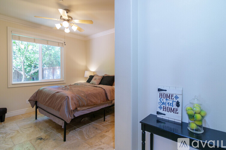 A bedroom with a bed and a sign that says "Home Sweet Home".