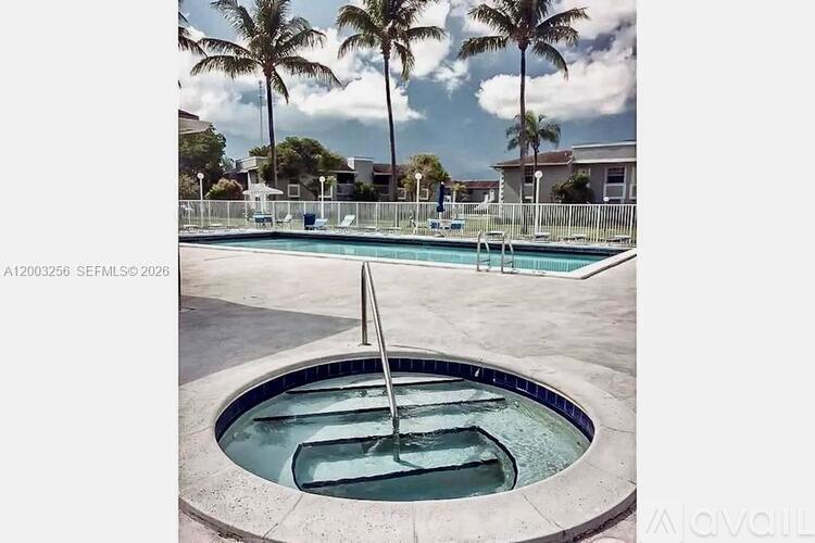 A pool with a hot tub in the middle of it.