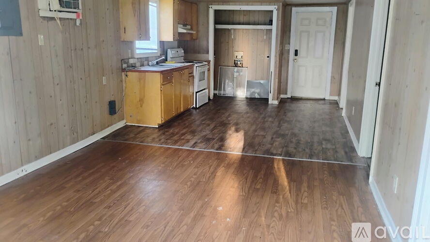 A kitchen with wooden floors and cabinets is available for rent.