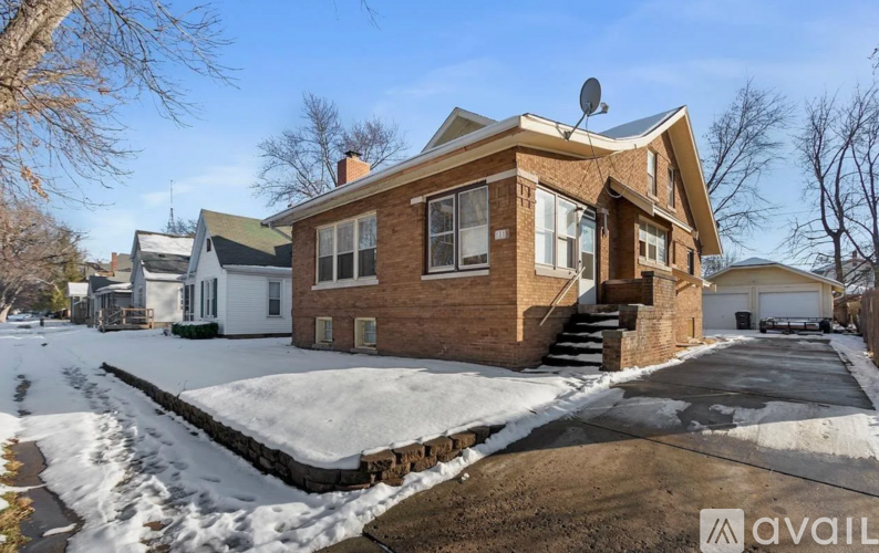 A house with a brown brick exterior is available for sale.