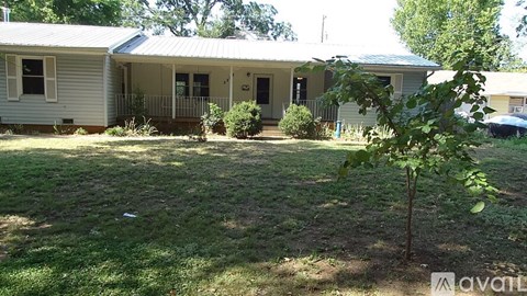 A house with a tree in front of it.