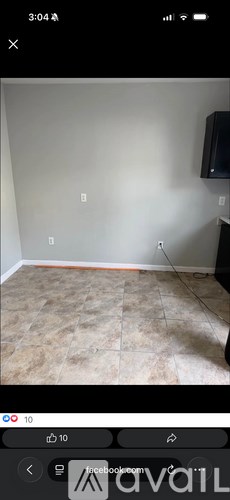 A room with a tiled floor and a wall socket.