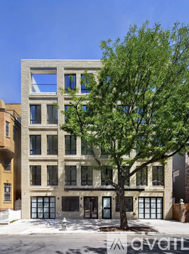 A modern building with a tree in front of it.