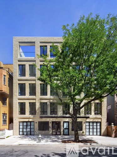 A modern building with a tree in front of it.