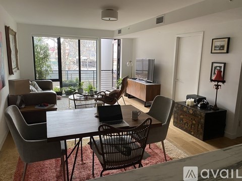 A living room with a dining table and chairs.