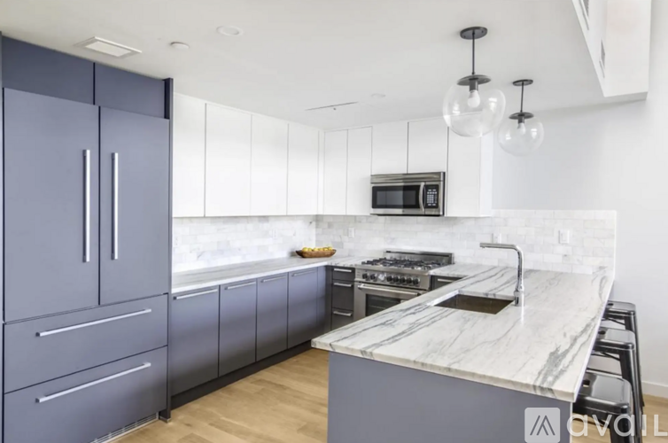 A modern kitchen with a marble countertop and a stove.