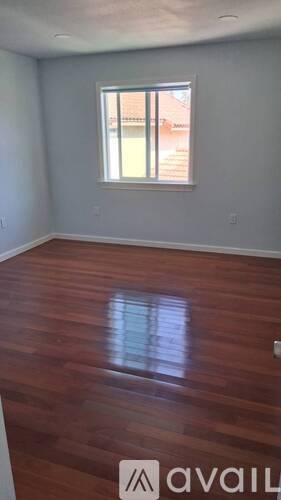 A room with wooden floors and a window.