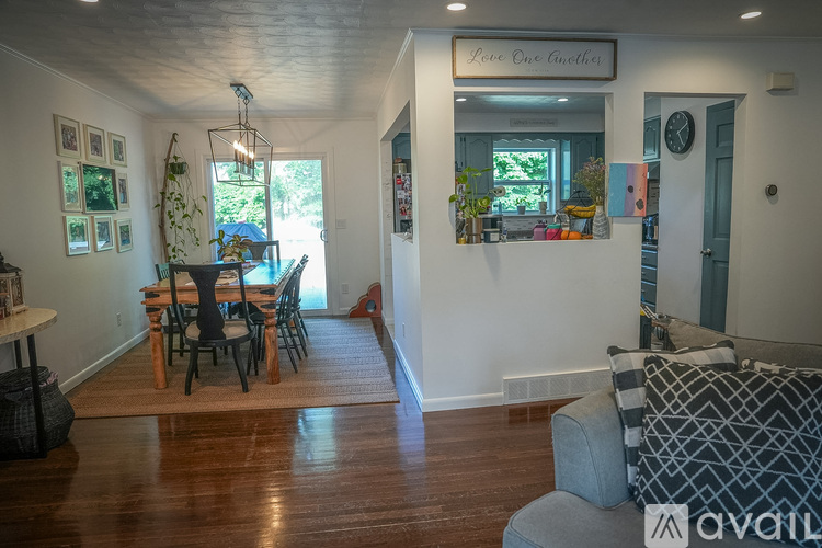 A living room with a dining table and chairs.