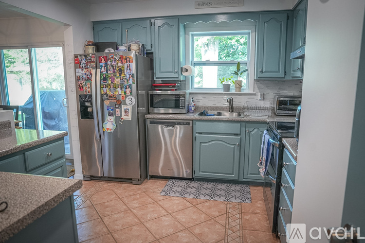 A kitchen with a refrigerator covered in magnets.