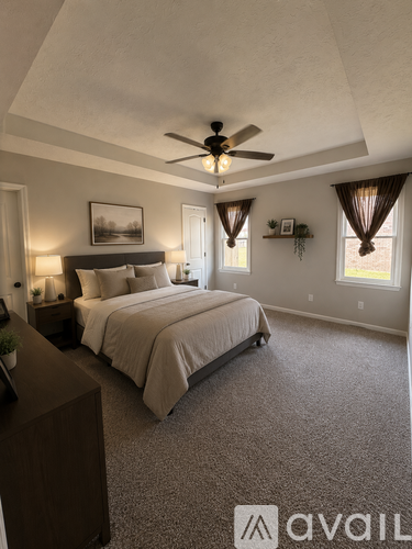 A bedroom with a large bed and a ceiling fan.