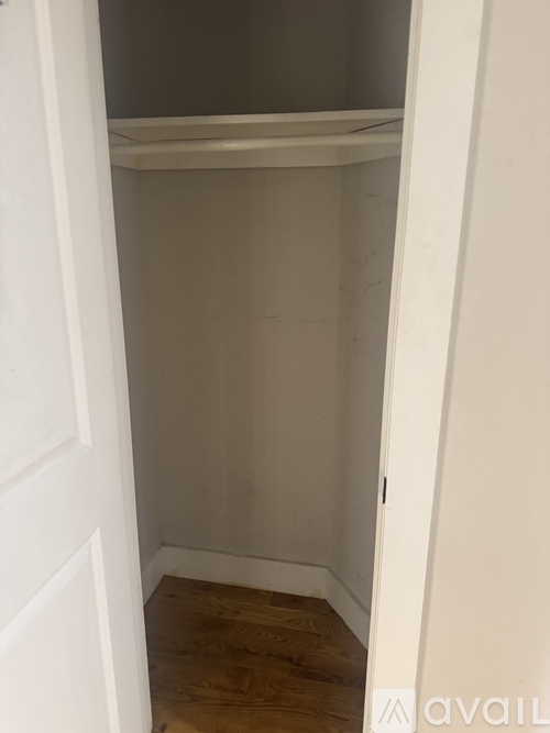A white door with a shelf above it.