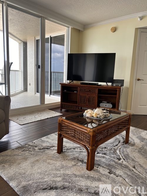 A living room with a flat screen TV on a wooden stand.