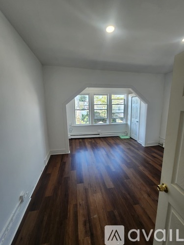 A room with wooden floors and a window.