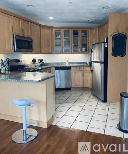 A kitchen with wooden cabinets and a white countertop.