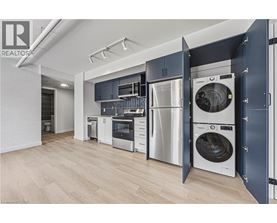A modern kitchen with a washing machine built into the cabinetry.