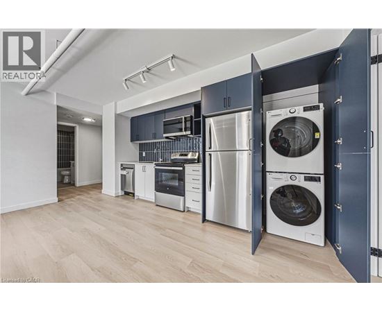 A modern kitchen with a washing machine built into the cabinetry.