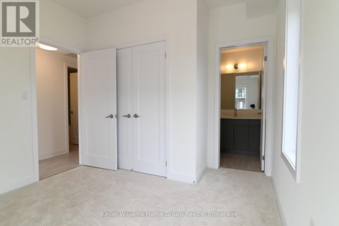 A white bedroom with a large closet and a mirror on the wall.