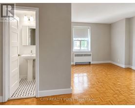 A bathroom with a toilet and sink is shown in a real estate listing.