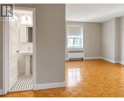 A bathroom with a toilet and sink is shown in a real estate listing.