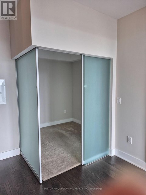 A room with a glass door and a carpet on the floor.