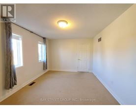 A room with a brokerage sign from Bay Street Group Inc.