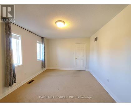 A room with a brokerage sign from Bay Street Group Inc.