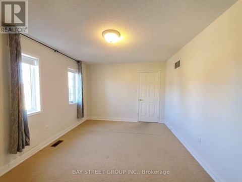 A room with a brokerage sign from Bay Street Group Inc.