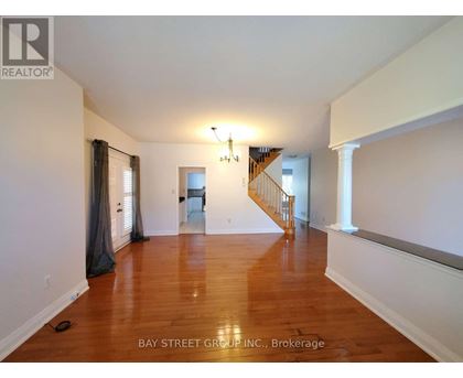 A room with wooden floors and a chandelier.