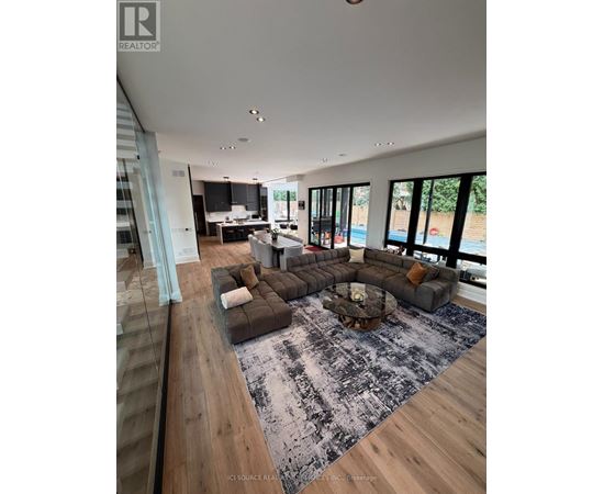 A modern living room with a large grey sofa and a coffee table.