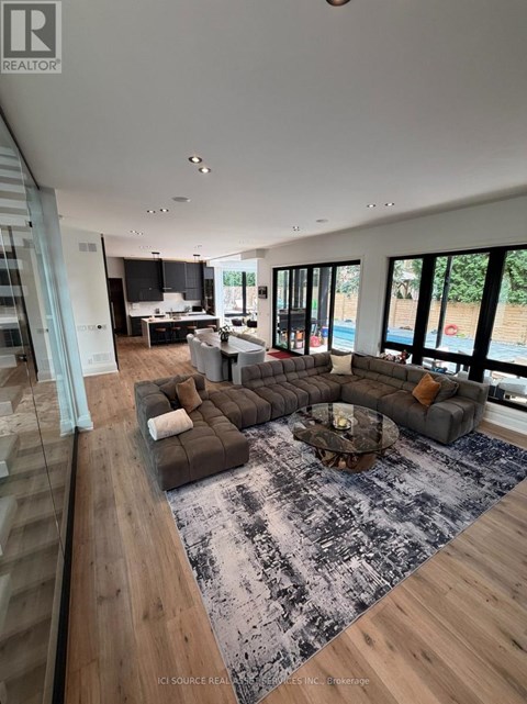 A modern living room with a large grey sofa and a coffee table.