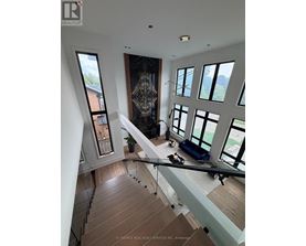 A modern interior space with a staircase leading to the upper level.