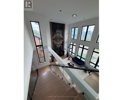 A modern interior space with a staircase leading to the upper level.
