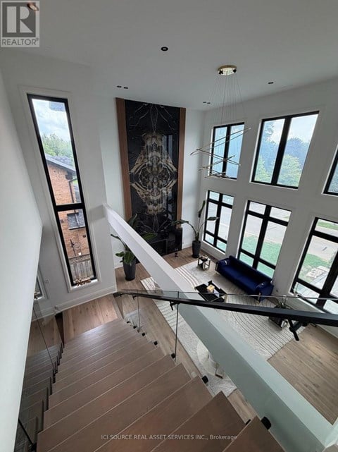 A modern interior space with a staircase leading to the upper level.