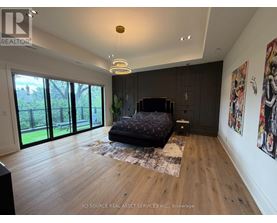 A bedroom with a large bed and a TV in the corner.