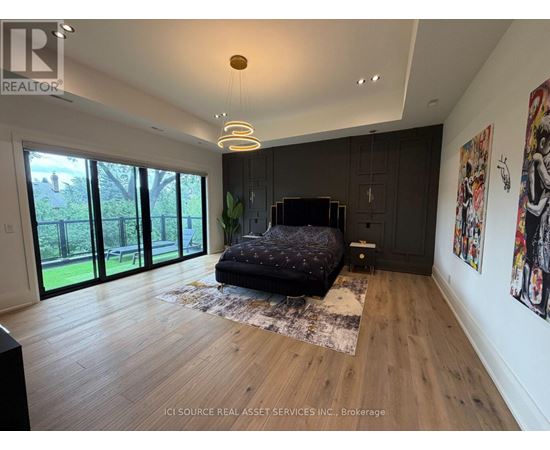 A bedroom with a large bed and a TV in the corner.
