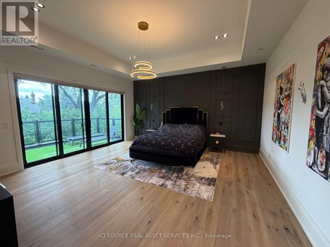 A bedroom with a large bed and a TV in the corner.